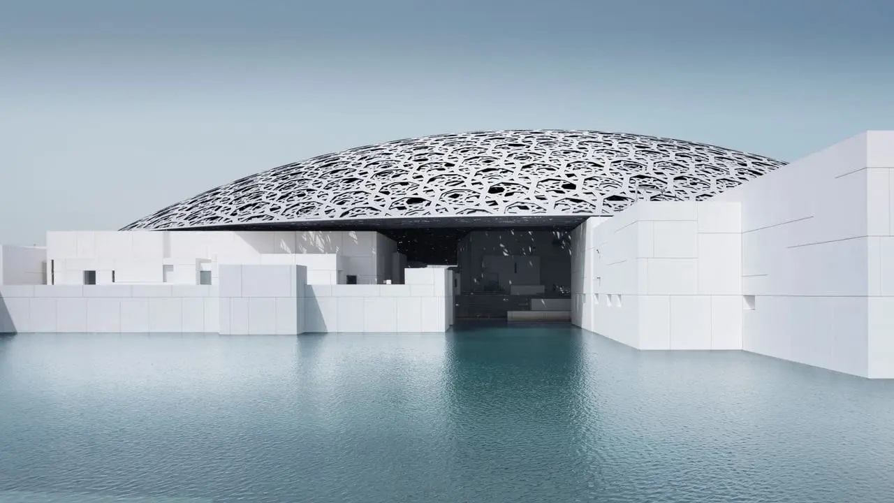 Photo of Exterior view of the Louvre Abu Dhabi museum featuring a large dome and white structures. | Wander Sober