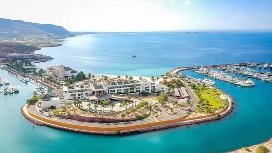 Photo of Aerial view of a coastal resort with a marina and surrounding water. | Wander Sober