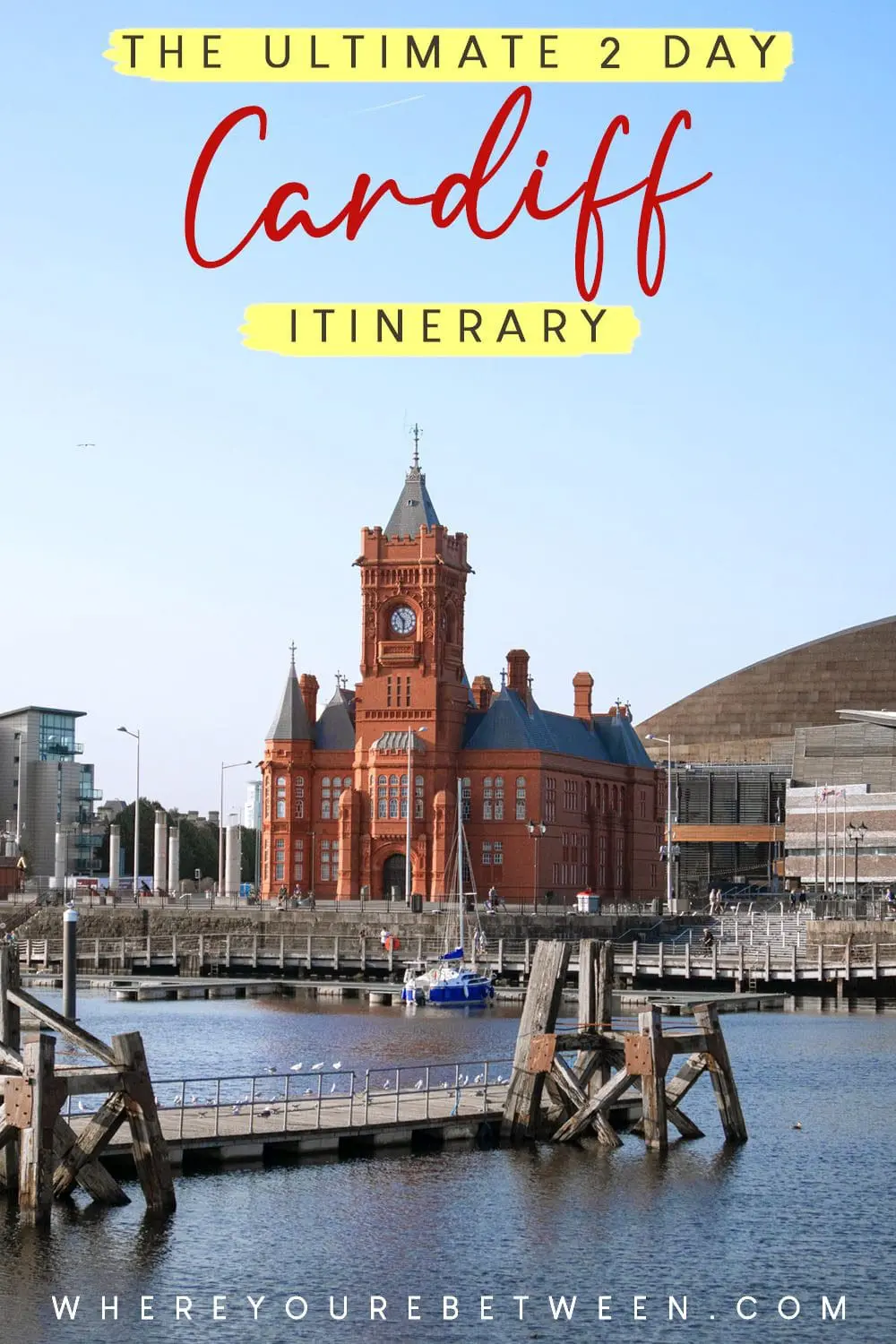 Photo of Red brick building of Cardiff City Hall near the waterfront with a clock tower. | Wander Sober