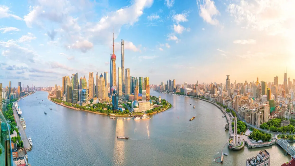 Photo of Panoramic view of the Shanghai skyline with the Huangpu River and modern skyscrapers. | Wander Sober