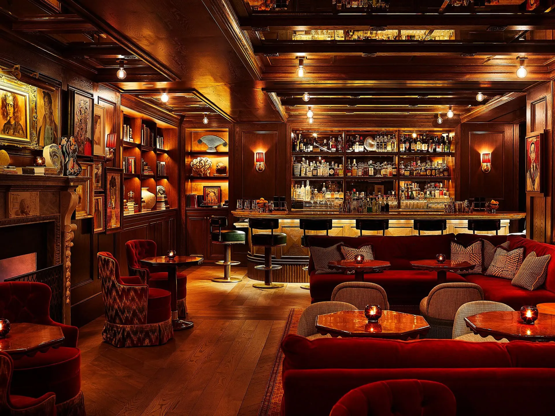 Photo of Interior view of a bar featuring red seating, wooden accents, and a well-stocked bar counter. | Wander Sober