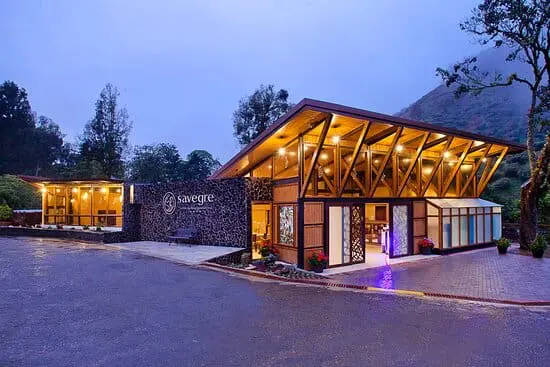 Photo of Contemporary building featuring a wooden structure and large glass windows at dusk. | Wander Sober