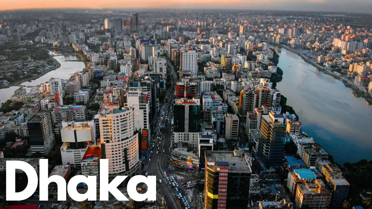 Photo of Aerial view of Dhaka city showcasing urban buildings and a river. | Wander Sober