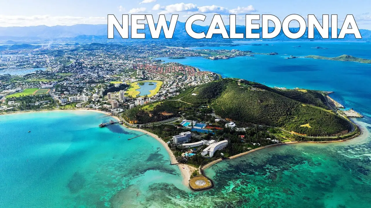 Photo of Aerial view of New Caledonia showcasing coastal areas and greenery. | Wander Sober