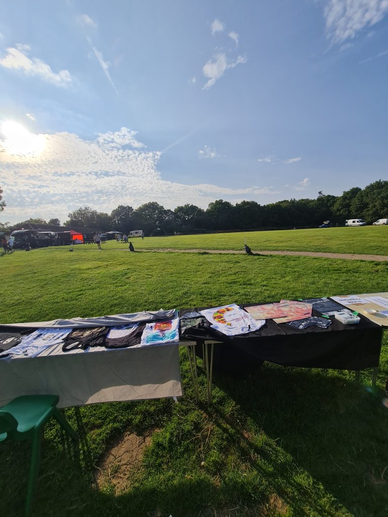 ADHD and how it manifests in me 4 Outdoor market scene with tables displaying art and crafts, surrounded by green grass and trees, promoting a sober lifestyle.