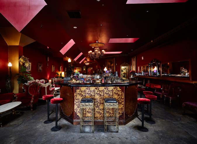 Photo of Interior view of a vintage bar featuring a dark red color scheme and ornate decor. | Wander Sober